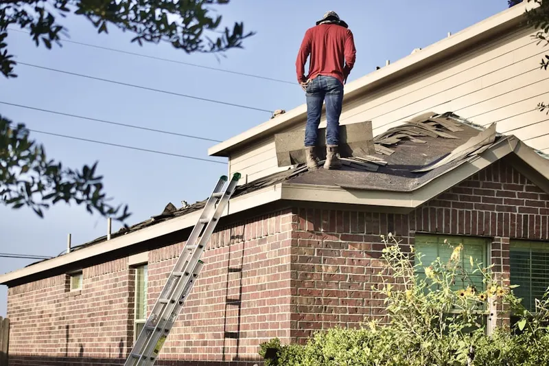 Professional roofer working on a residential roof in Broussard